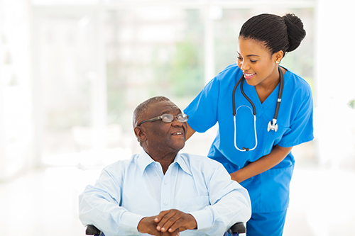 Elderly man looking up and shaking hands with someone